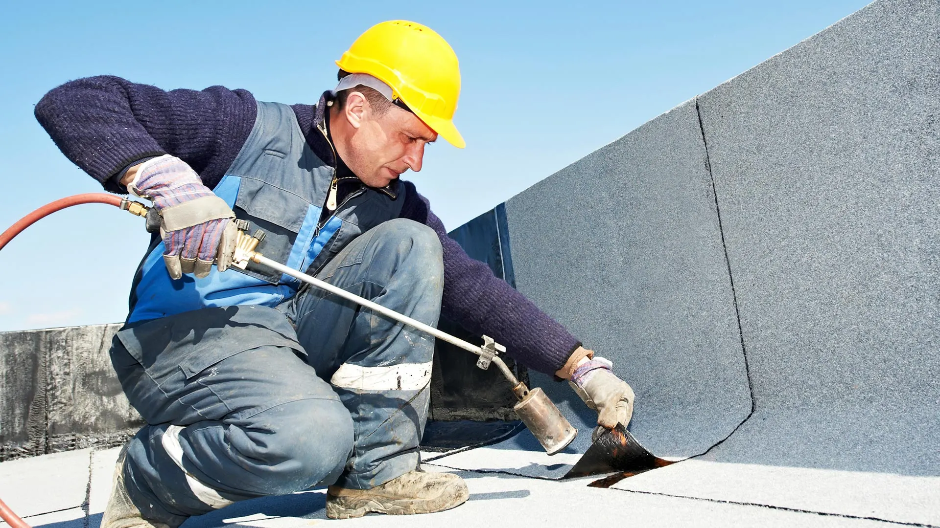 Roofer laying a flat roof